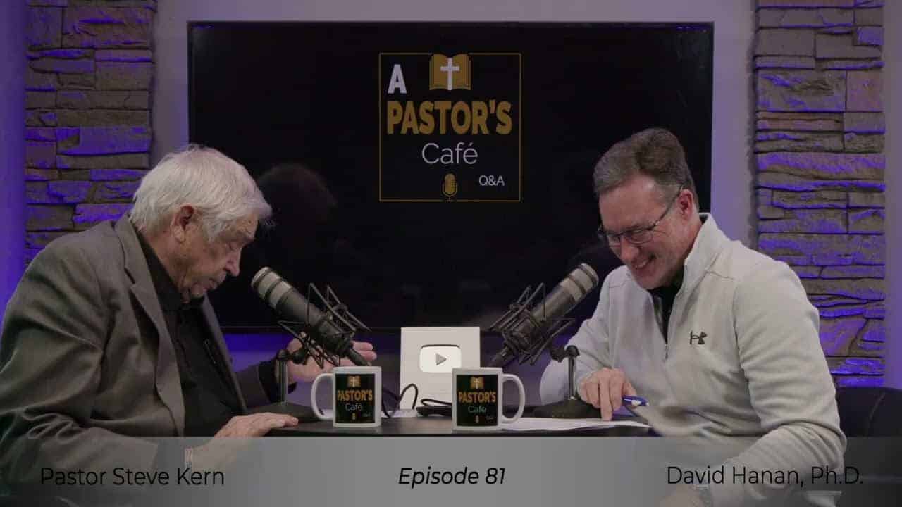 Pastors engaging in training at Liberty Pastors event with microphones and coffee mugs.