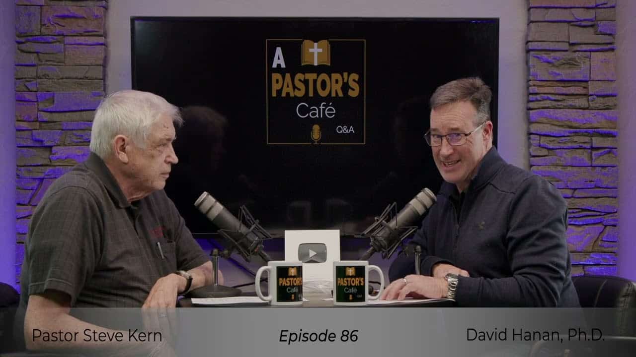 Two pastors engaged in a training session at Liberty Pastors Cafe with microphones and recording equ.