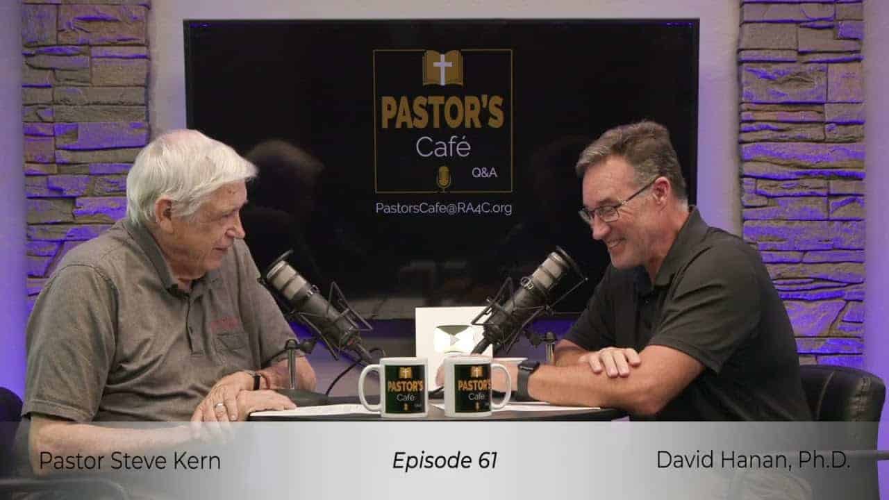 Pastors training session with two speakers discussing faith and leadership.