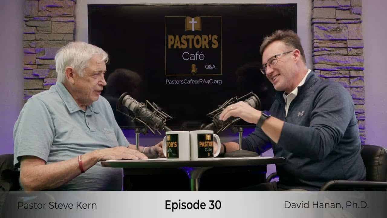 Pastors training session with two men discussing ministry strategies.